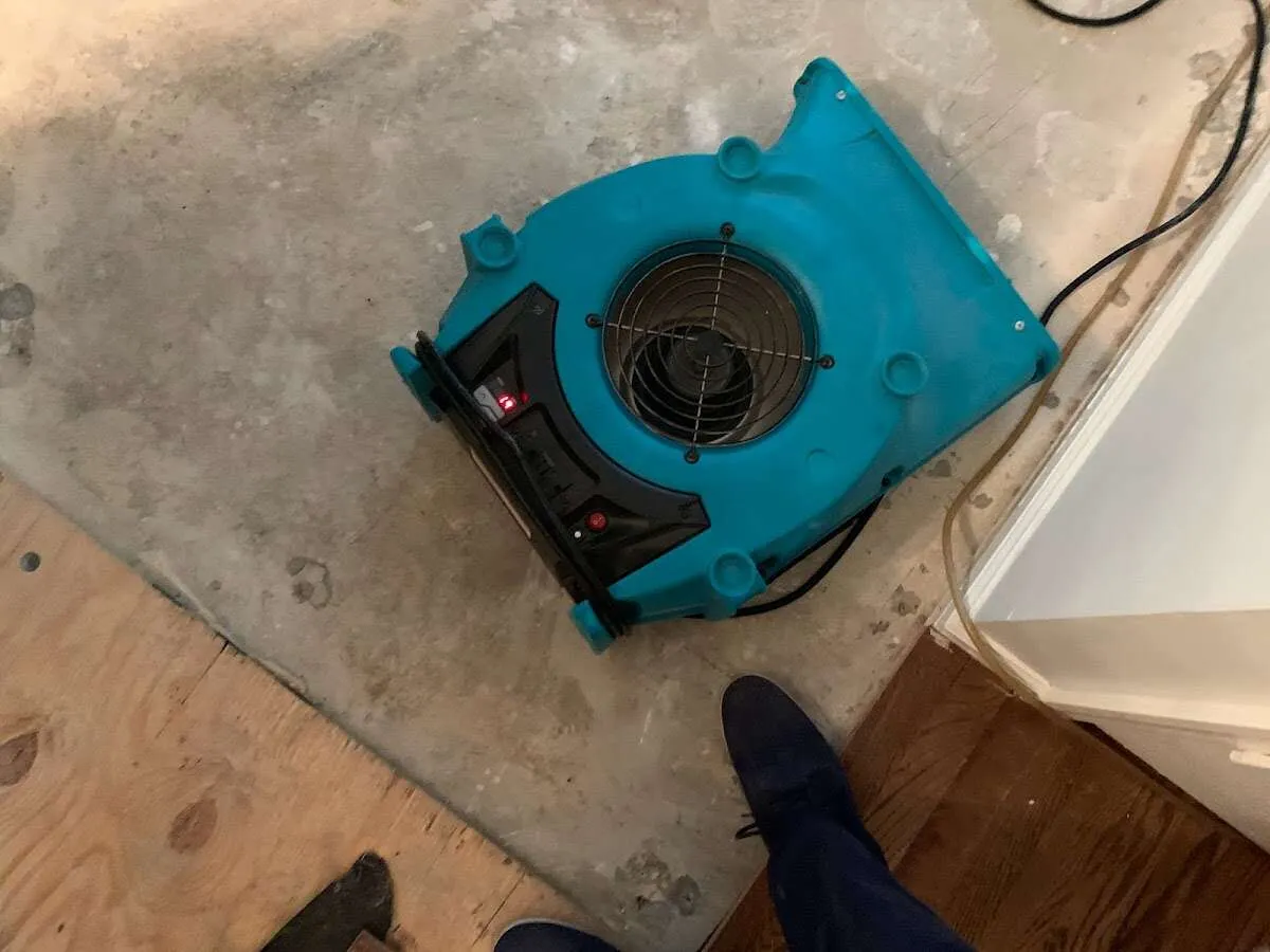 Air mover drying subfloor during Leak Detection & Repair in Oakley